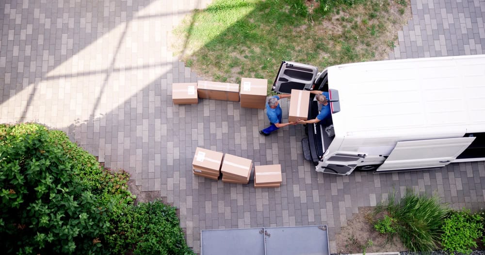 Delivery truck movers moving furniture and loading a van in Long Island, NY.
